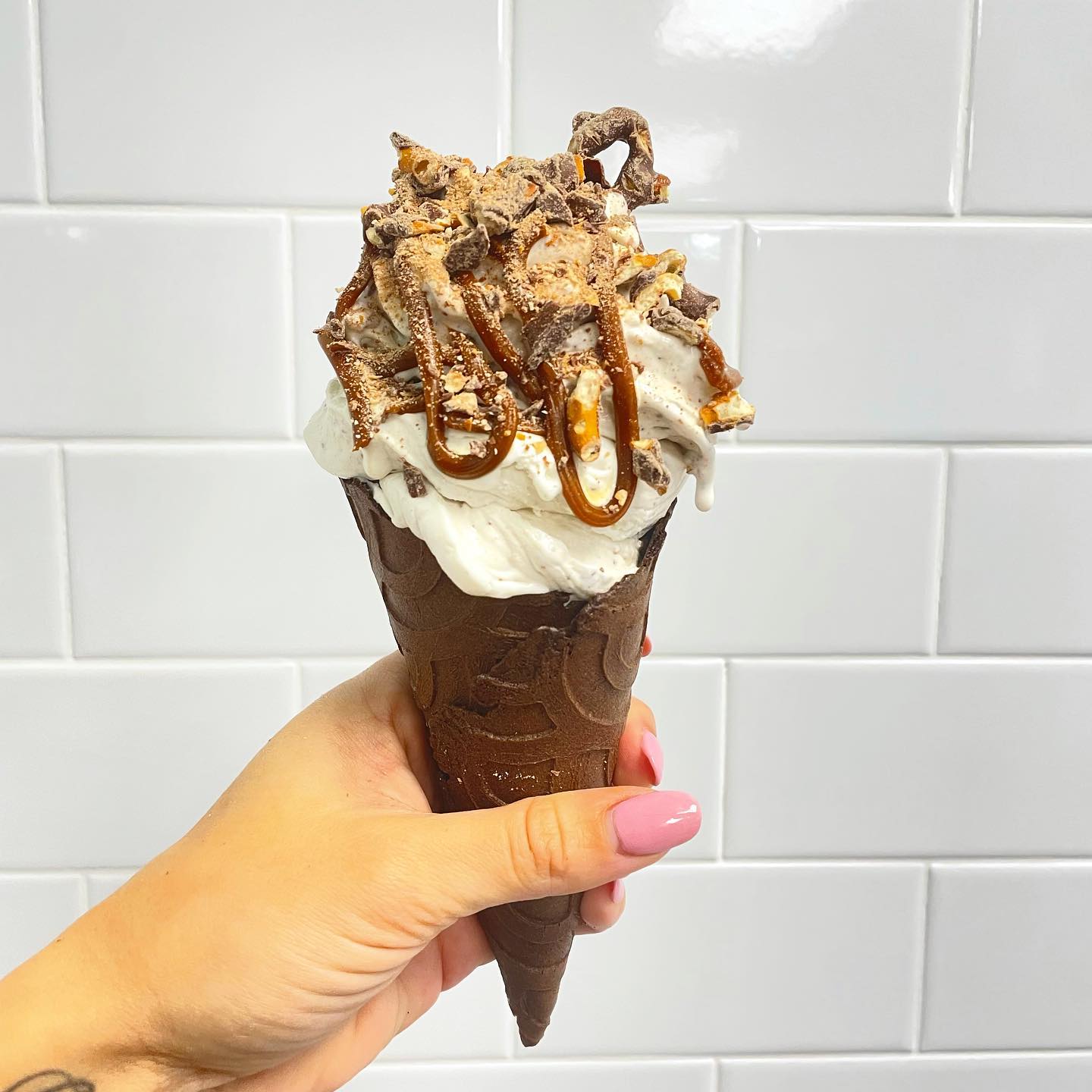 vanilla ice cream with chocolate covered pretzels on a chocolate cone